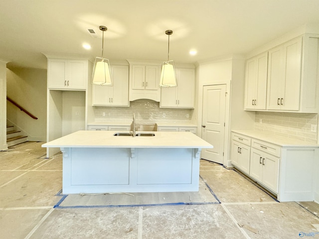 kitchen featuring pendant lighting, light countertops, and white cabinetry