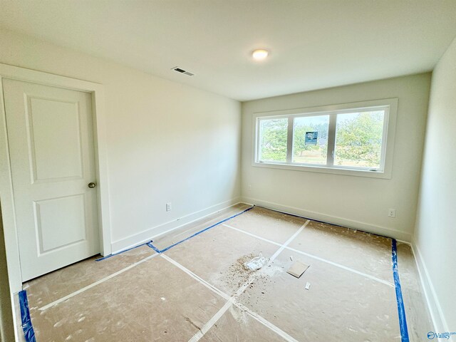 unfurnished bedroom with visible vents and baseboards