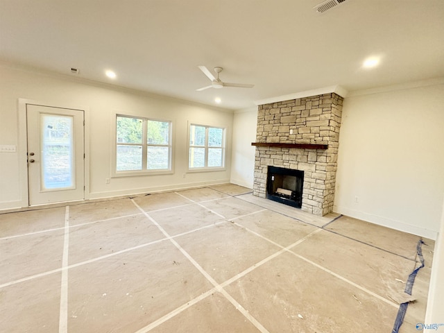 unfurnished living room featuring recessed lighting, ornamental molding, a ceiling fan, a stone fireplace, and baseboards