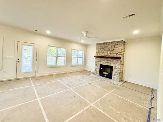 unfurnished living room featuring baseboards, visible vents, a ceiling fan, crown molding, and a stone fireplace