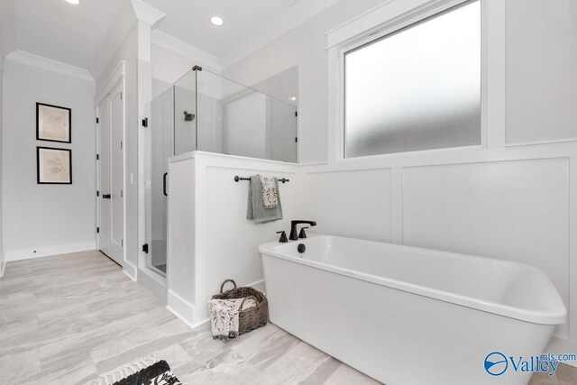 bathroom with independent shower and bath and ornamental molding