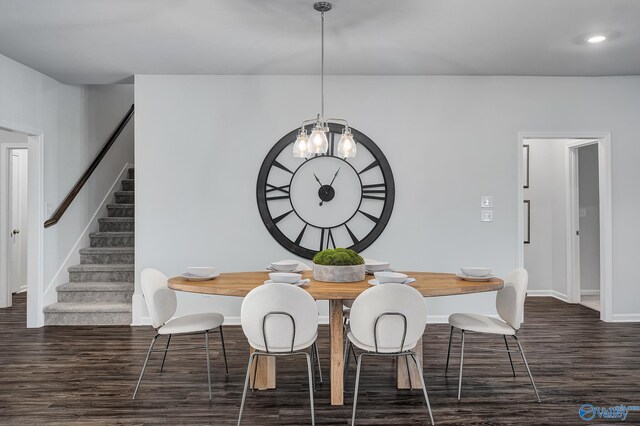 dining space featuring dark hardwood / wood-style floors and a chandelier