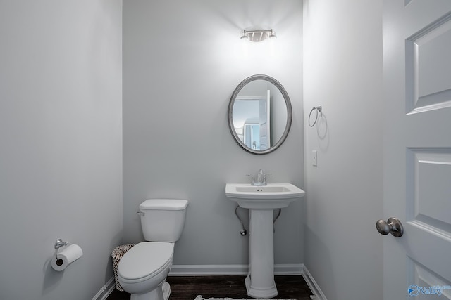 bathroom featuring sink, wood-type flooring, and toilet