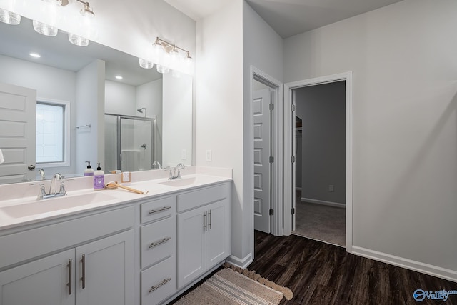 bathroom featuring walk in shower, vanity, and hardwood / wood-style flooring