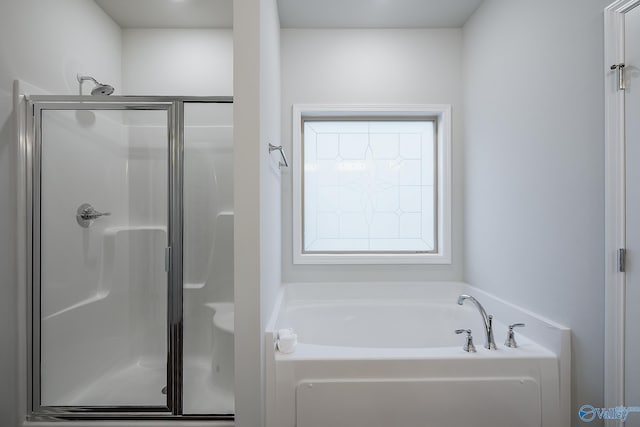 bathroom with shower with separate bathtub