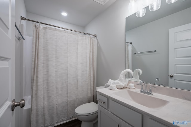 bathroom featuring vanity, toilet, and a shower with shower curtain