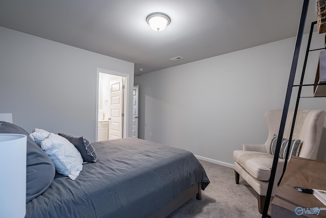 bedroom with light carpet and connected bathroom