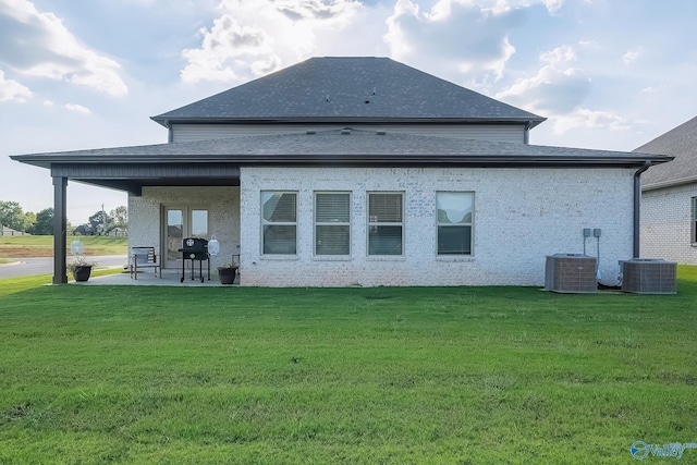 back of property featuring a patio, central AC unit, and a lawn