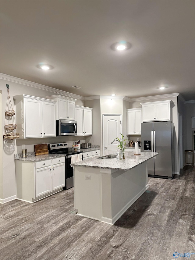 kitchen with hardwood / wood-style floors, white cabinets, stainless steel appliances, and sink