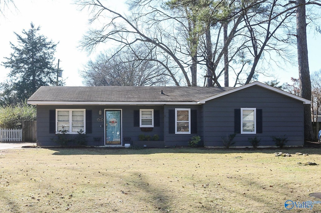 ranch-style home with a front lawn