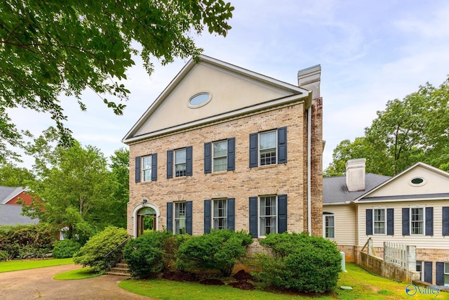 11086 Drennen Dr, Tanner, AL 35671 - neoclassical home featuring brick siding, a front lawn, and a chimney