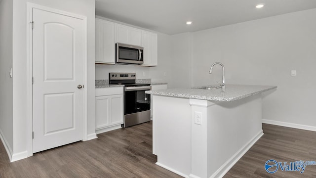 123 Trestle Point Dr, Harvest, AL 35749 - kitchen featuring appliances with stainless steel finishes, a sink, dark wood-style flooring, a kitchen island with sink, and recessed lighting