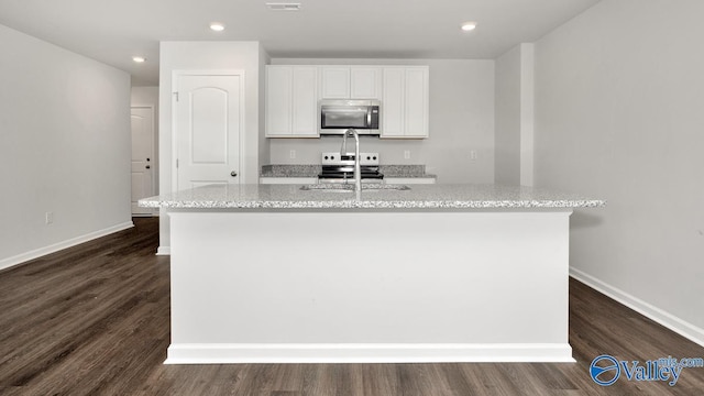 123 Trestle Point Dr, Harvest, AL 35749 - kitchen with appliances with stainless steel finishes, a sink, a kitchen island with sink, light stone countertops, and baseboards
