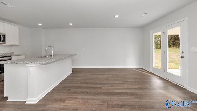 123 Trestle Point Dr, Harvest, AL 35749 - kitchen featuring stainless steel appliances, a sink, dark wood finished floors, white cabinetry, and baseboards