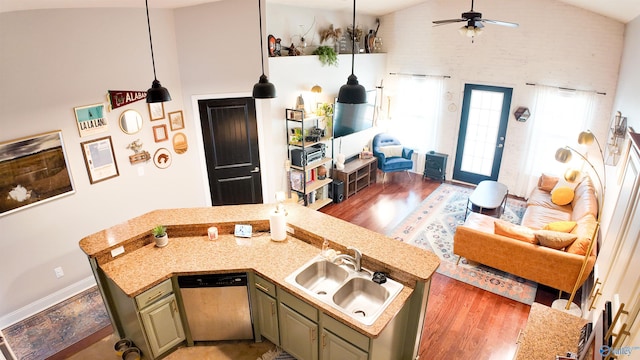 kitchen featuring sink, wood-type flooring, high vaulted ceiling, dishwashing machine, and green cabinets