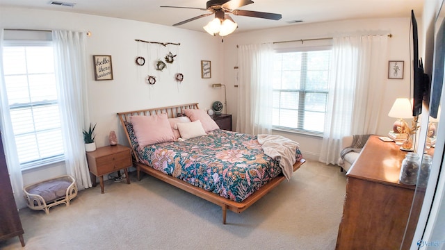 bedroom featuring ceiling fan and carpet