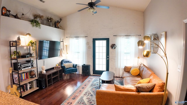 living room featuring dark wood-type flooring, ceiling fan, and high vaulted ceiling