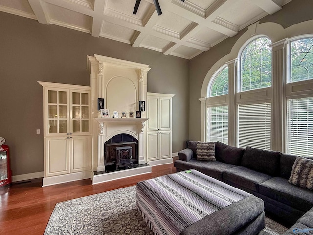 166 Hickory Rdg, Glencoe, AL 35905 - living room with dark wood-style flooring, coffered ceiling, a wood stove, beam ceiling, and baseboards