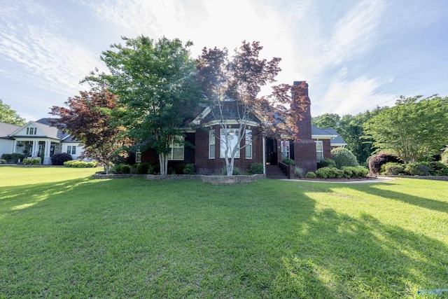 166 Hickory Rdg, Glencoe, AL 35905 - view of front of home featuring a front lawn, a chimney, and brick siding