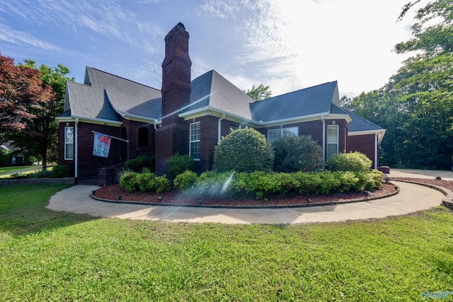 166 Hickory Rdg, Glencoe, AL 35905 - view of front facade with brick siding, a chimney, a front lawn, and roof with shingles