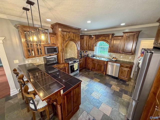 166 Hickory Rdg, Glencoe, AL 35905 - kitchen featuring appliances with stainless steel finishes, a peninsula, stone tile floors, brown cabinetry, and recessed lighting