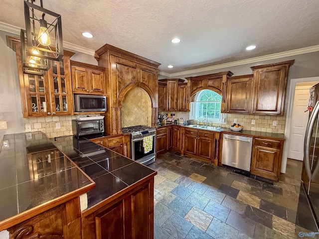 166 Hickory Rdg, Glencoe, AL 35905 - kitchen featuring appliances with stainless steel finishes, a sink, crown molding, brown cabinets, and stone tile flooring