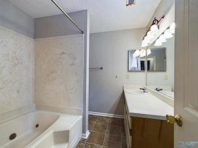 bathroom with vanity, a tub, a textured ceiling, and tile patterned floors