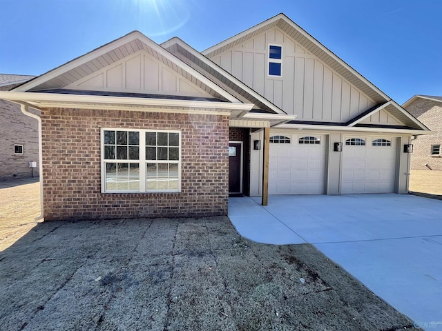 view of front of house with board and batten siding, concrete driveway, brick siding, and an attached garage