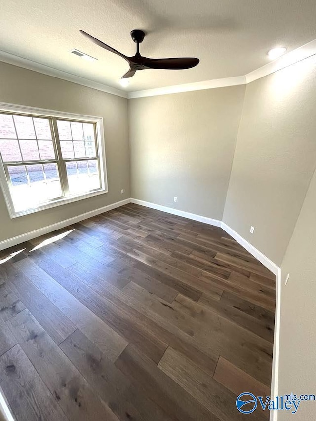 unfurnished room featuring ceiling fan, a textured ceiling, ornamental molding, and dark wood-style flooring