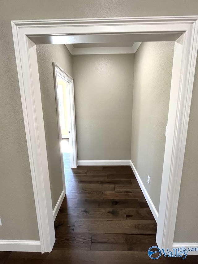 hall featuring dark wood finished floors and baseboards