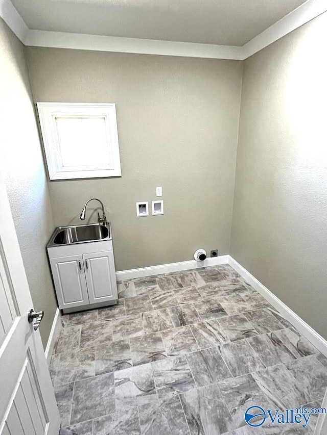 washroom featuring washer hookup, a sink, cabinet space, and baseboards