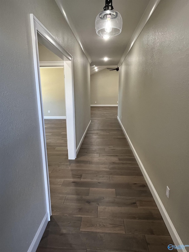 hall with dark wood finished floors and baseboards