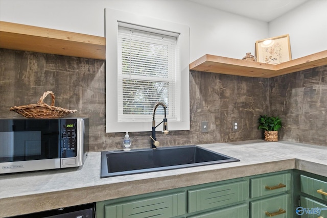 kitchen with sink, green cabinetry, and plenty of natural light