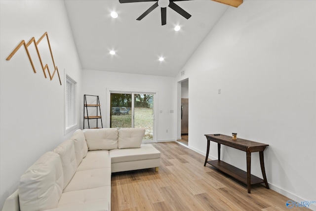 living room featuring light hardwood / wood-style floors, high vaulted ceiling, and ceiling fan