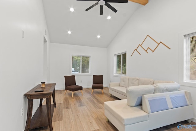 living room featuring high vaulted ceiling, light wood-type flooring, and ceiling fan