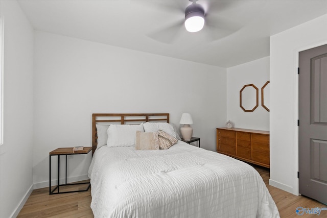 bedroom with ceiling fan and light hardwood / wood-style flooring