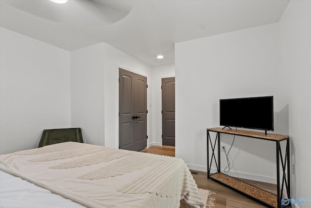 bedroom featuring ceiling fan and wood-type flooring