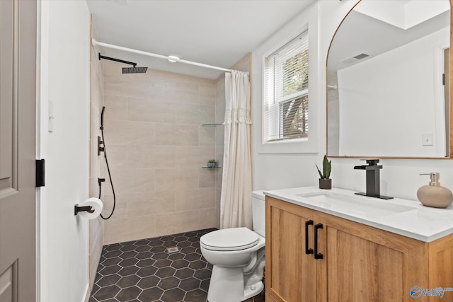 bathroom featuring vanity, a shower with shower curtain, toilet, and tile patterned flooring