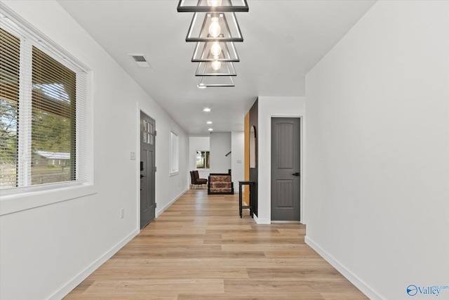 hallway with light hardwood / wood-style flooring