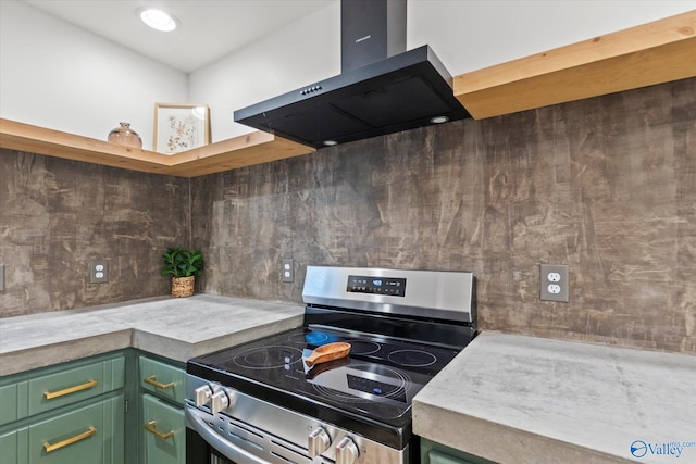 kitchen with ventilation hood, green cabinetry, stainless steel electric range oven, and tasteful backsplash