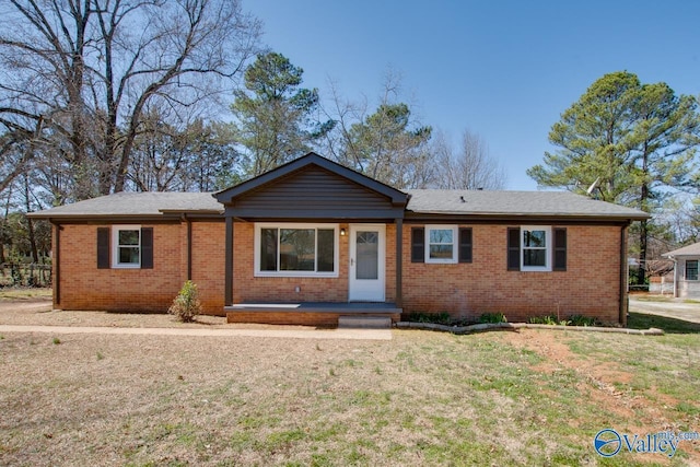 ranch-style house with brick siding and a front lawn