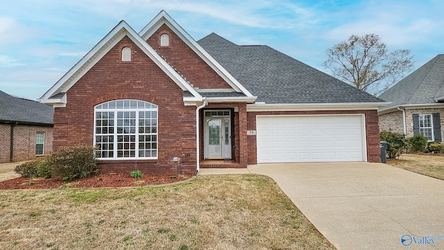 view of front facade featuring concrete driveway, a garage, a front lawn, brick siding, and a shingled roof