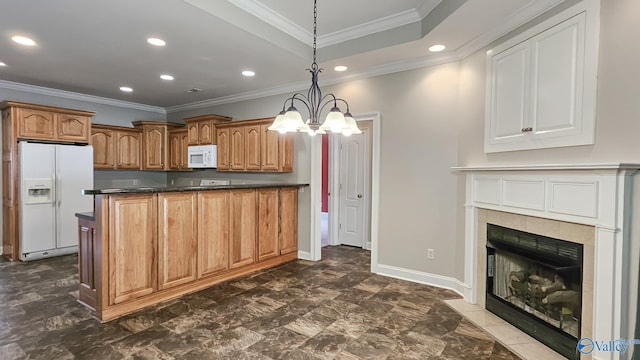 kitchen with decorative light fixtures, recessed lighting, white appliances, dark countertops, and a tile fireplace