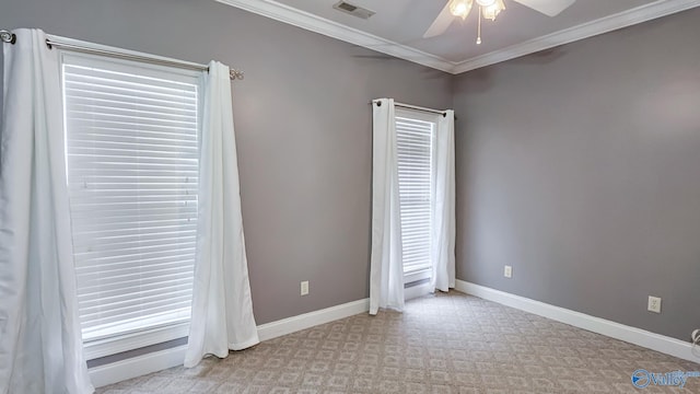 unfurnished room with crown molding, baseboards, visible vents, a ceiling fan, and light carpet