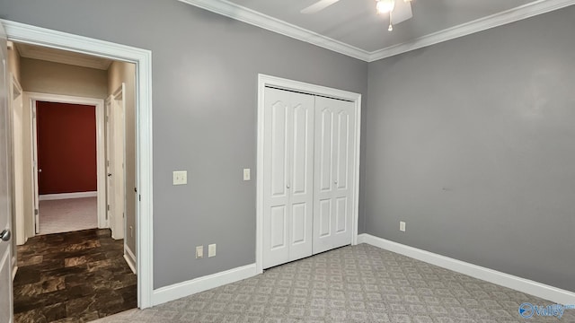 unfurnished bedroom with baseboards, ceiling fan, a closet, and crown molding