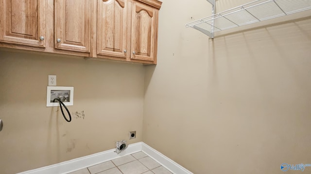 washroom featuring tile patterned floors, hookup for an electric dryer, baseboards, cabinet space, and hookup for a washing machine