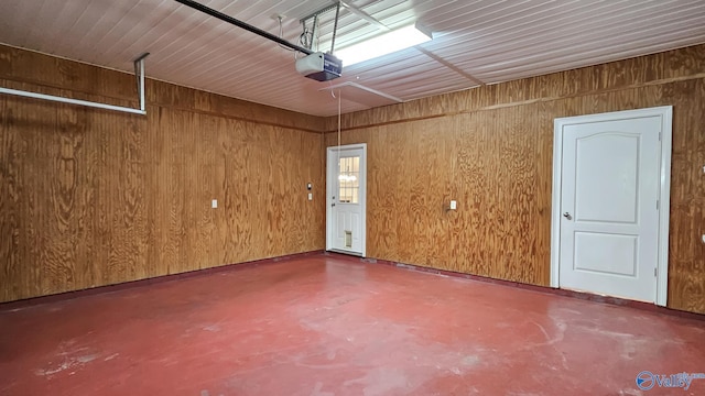 garage with wooden walls and a garage door opener