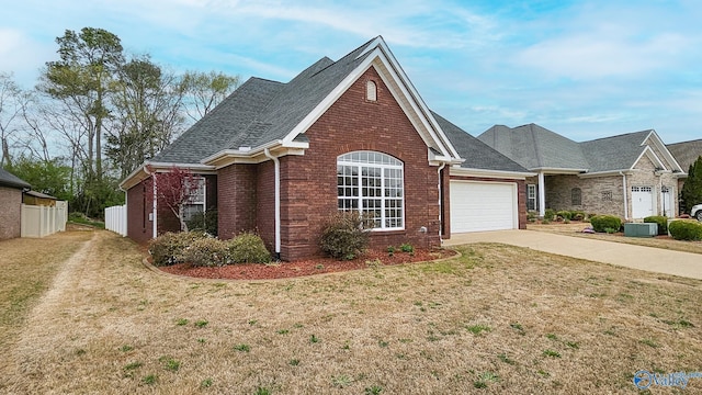 view of front of house with a front yard, brick siding, concrete driveway, and an attached garage