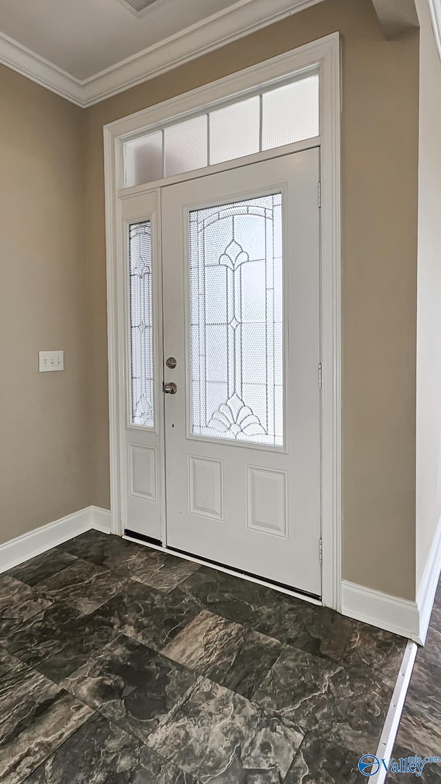 entryway featuring baseboards, marble finish floor, ornamental molding, and a wealth of natural light