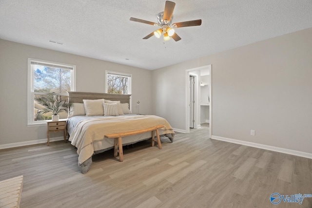 1816 Devonshire Dr SE, Decatur, AL 35601 - bedroom with light wood finished floors, a textured ceiling, baseboards, and a ceiling fan
